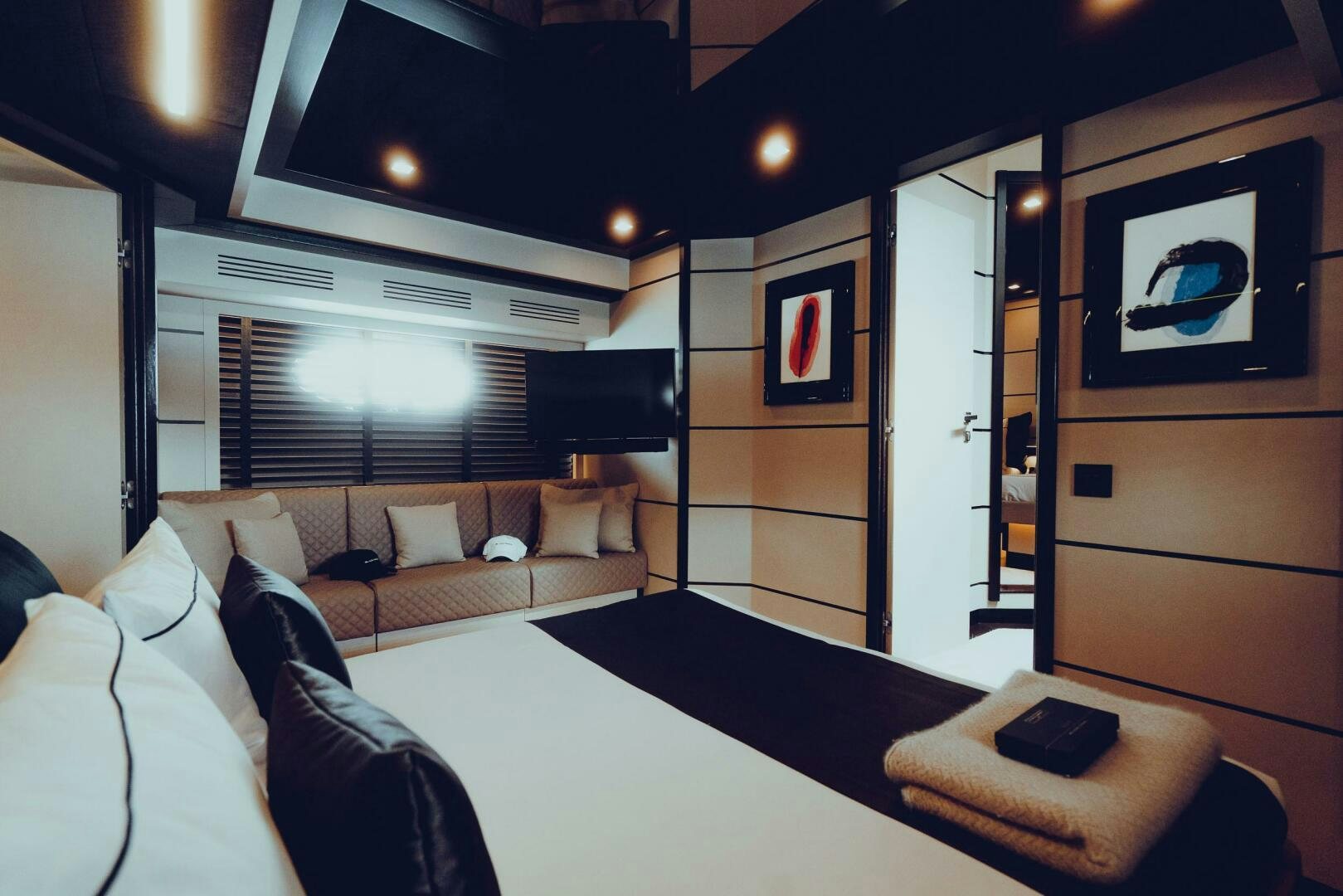 a room with a couch and a table with a white tablecloth aboard BLACK ROCK Yacht for Sale