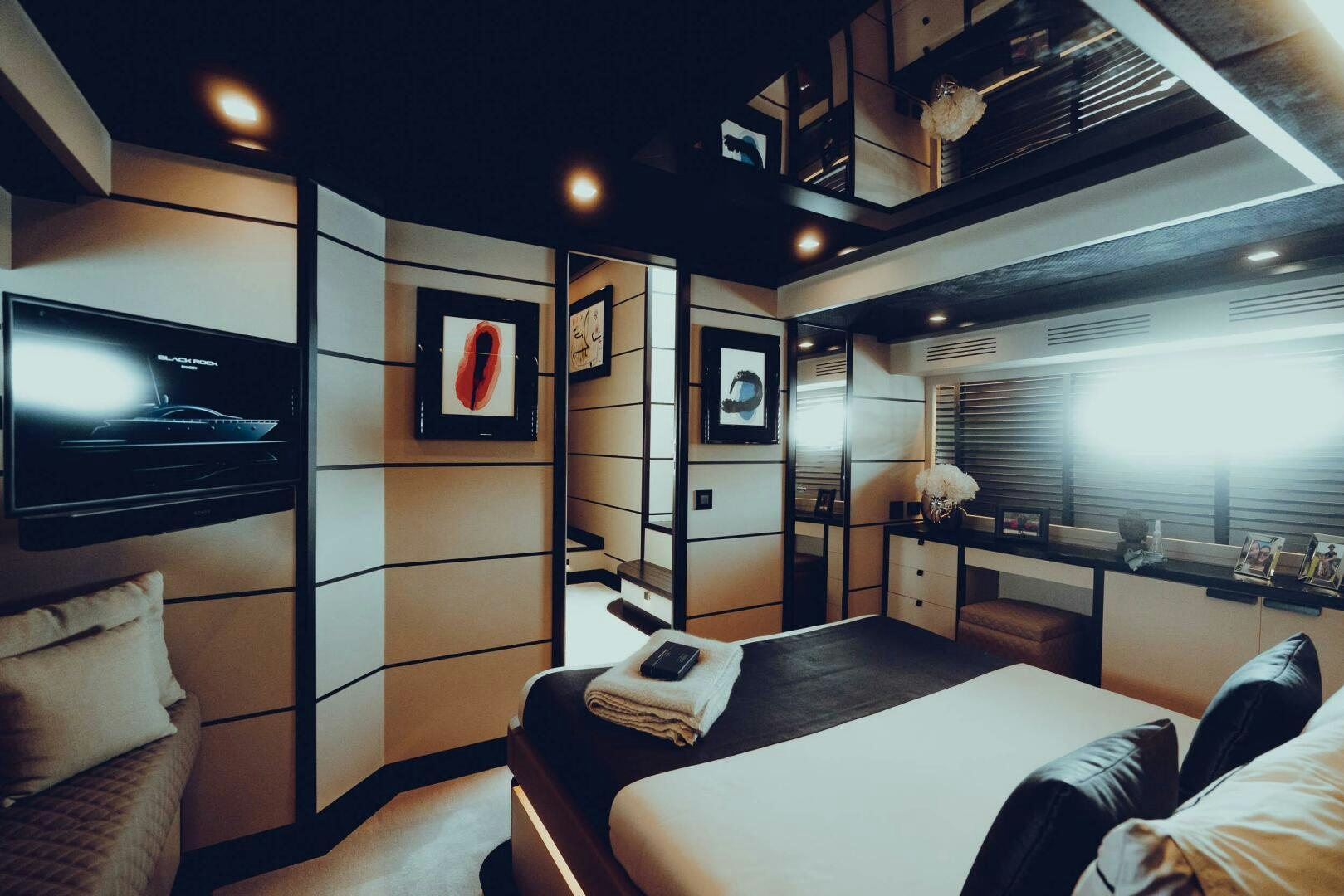 a room with a bed and a desk aboard BLACK ROCK Yacht for Sale