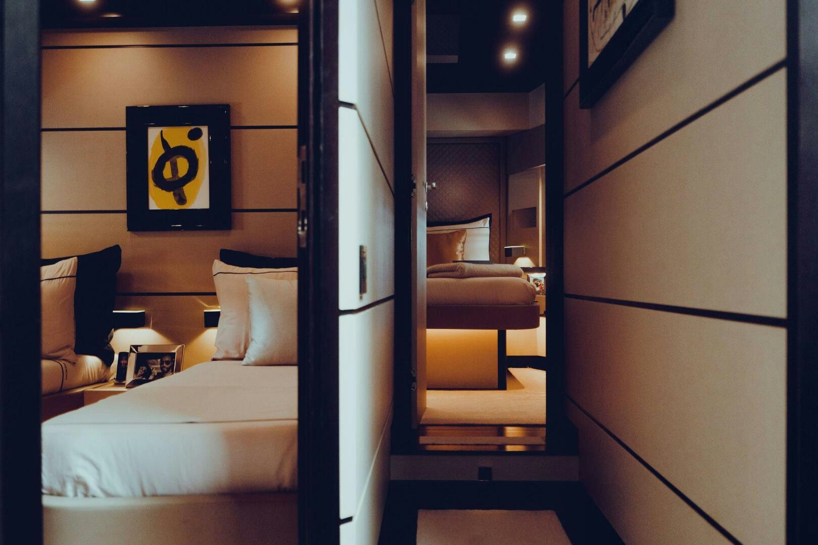 a room with a bed and a mirror aboard BLACK ROCK Yacht for Sale