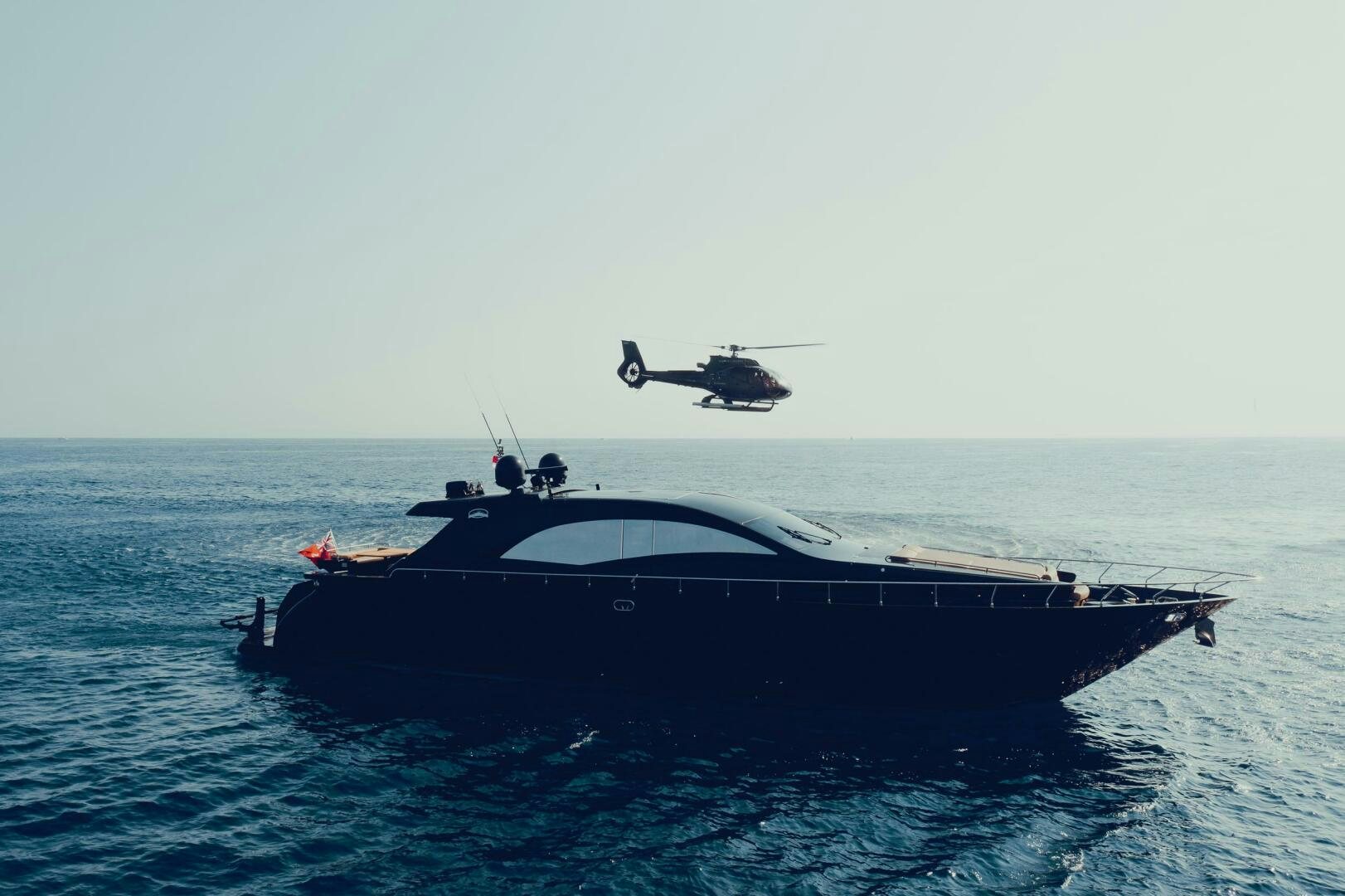 a helicopter flying over a boat aboard BLACK ROCK Yacht for Sale