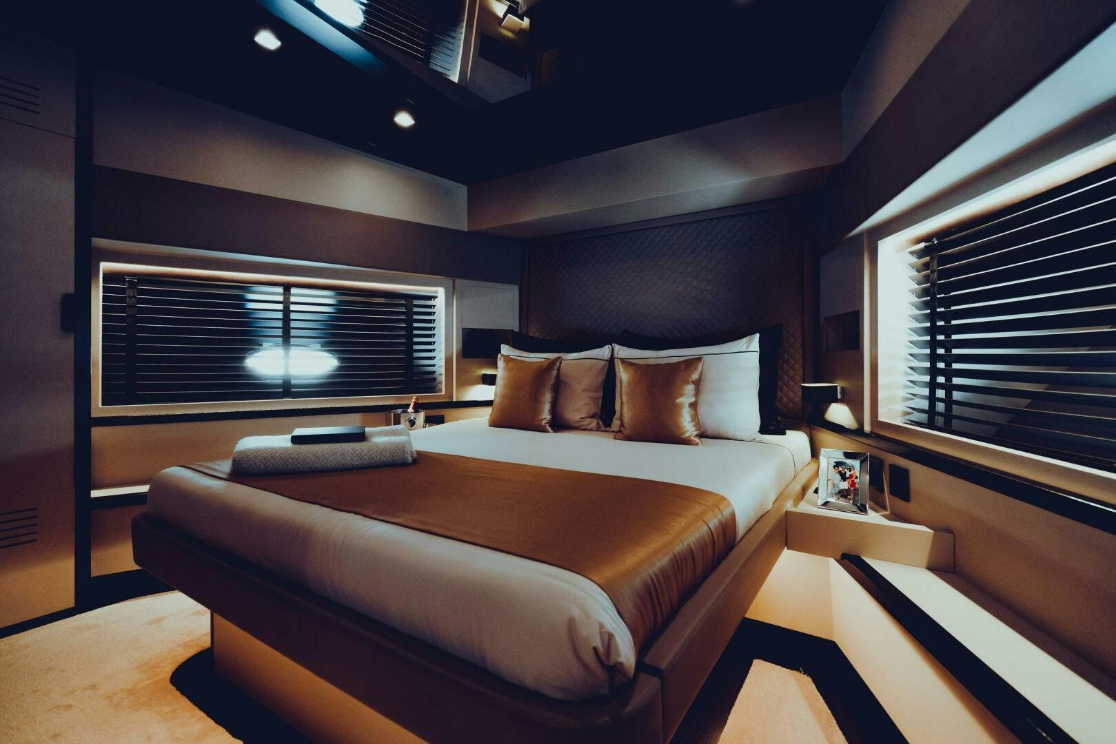 a room with a bed and a window aboard BLACK ROCK Yacht for Sale