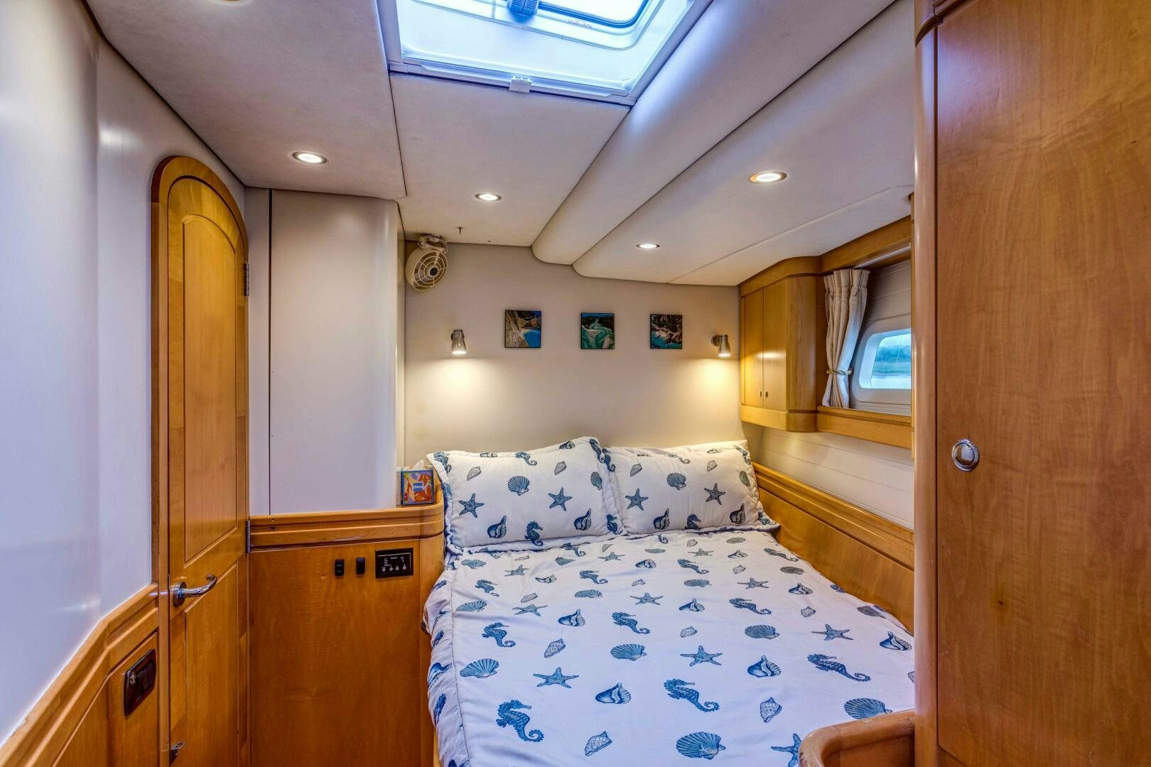 a bedroom with a bed and a door aboard LADY K Yacht for Sale