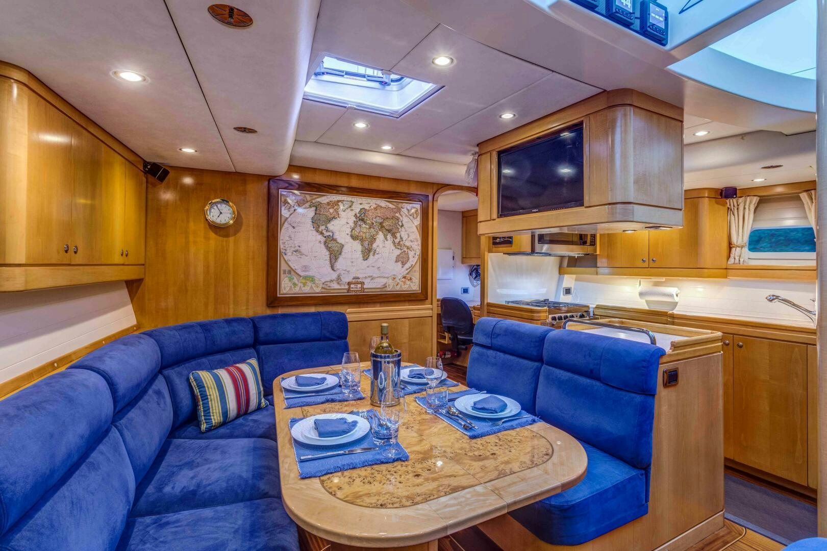 a living room with a blue couch aboard LADY K Yacht for Sale