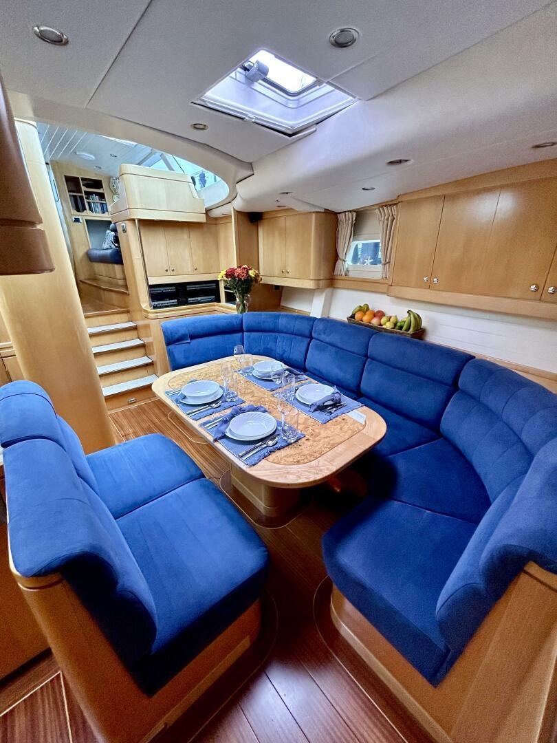 a living room with a blue couch aboard LADY K Yacht for Sale