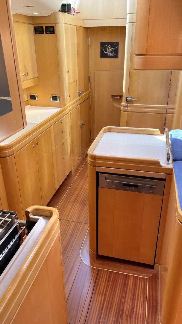 a kitchen with wooden cabinets aboard LADY K Yacht for Sale