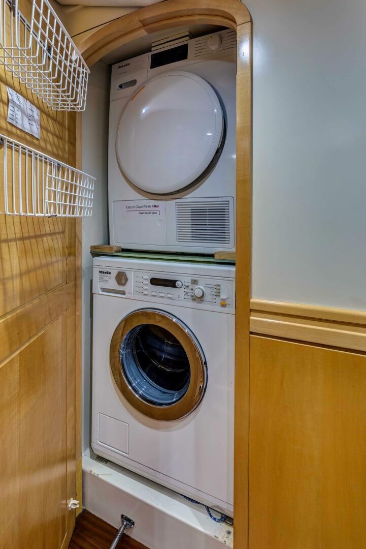 a washing machine in a room aboard LADY K Yacht for Sale