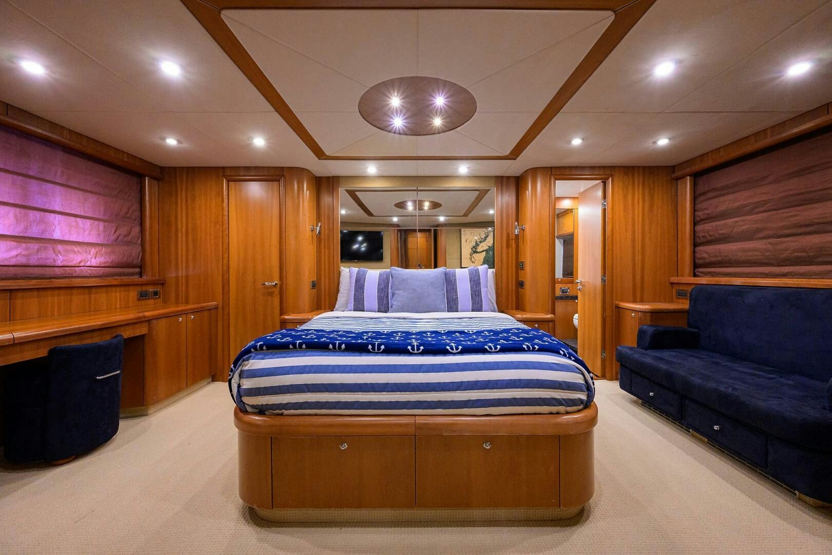 a bedroom with a bed and a couch aboard THE SHI Yacht for Sale