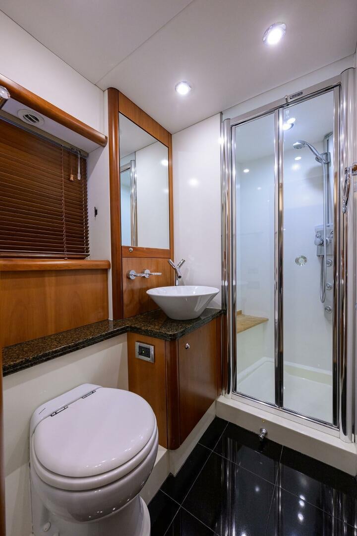 a bathroom with a glass shower aboard THE SHI Yacht for Sale