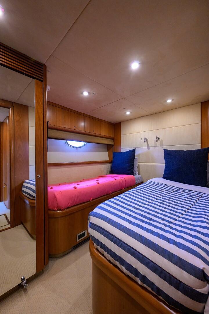 a room with a bed and a mirror aboard THE SHI Yacht for Sale