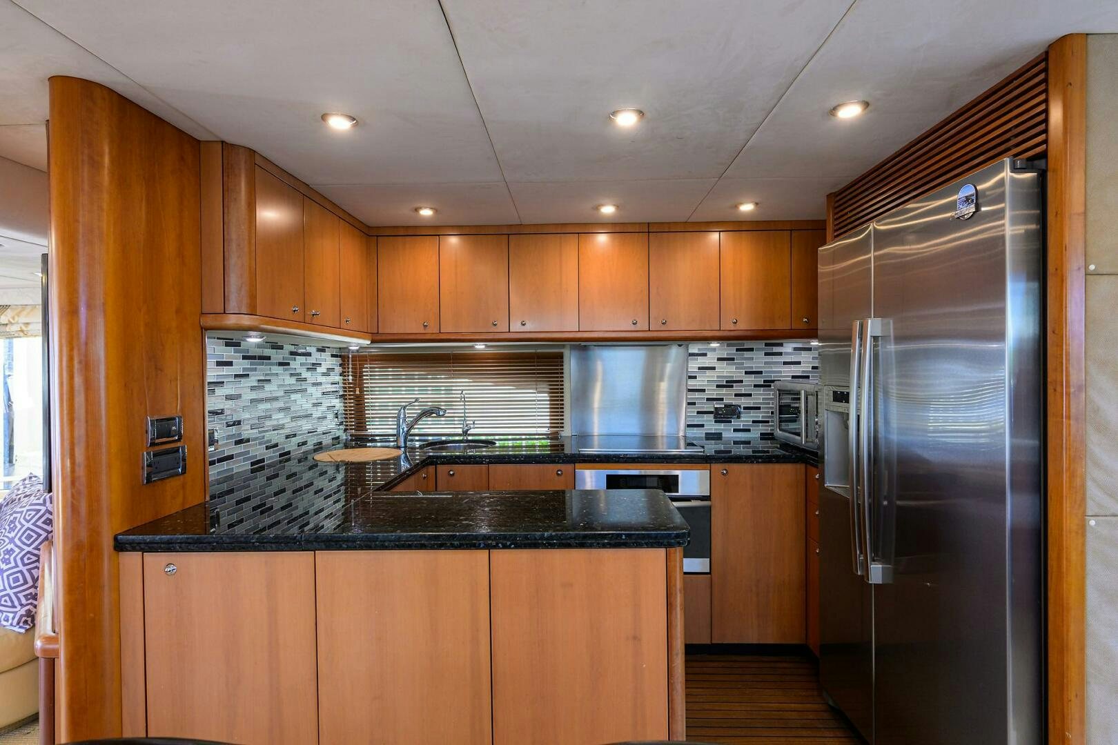 a kitchen with wooden cabinets aboard THE SHI Yacht for Sale