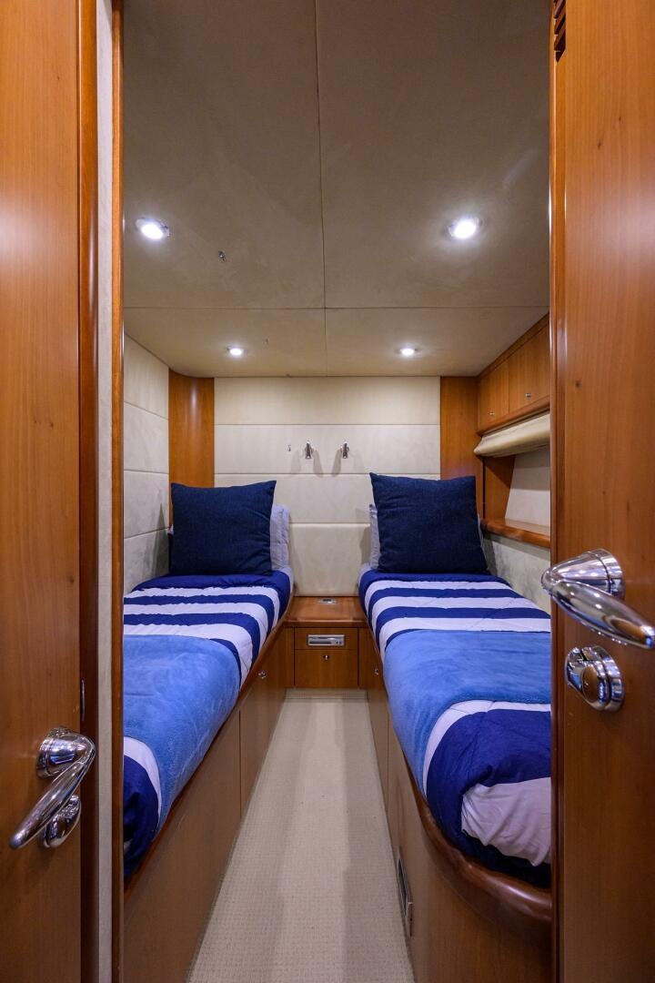 a room with a couple of beds aboard THE SHI Yacht for Sale
