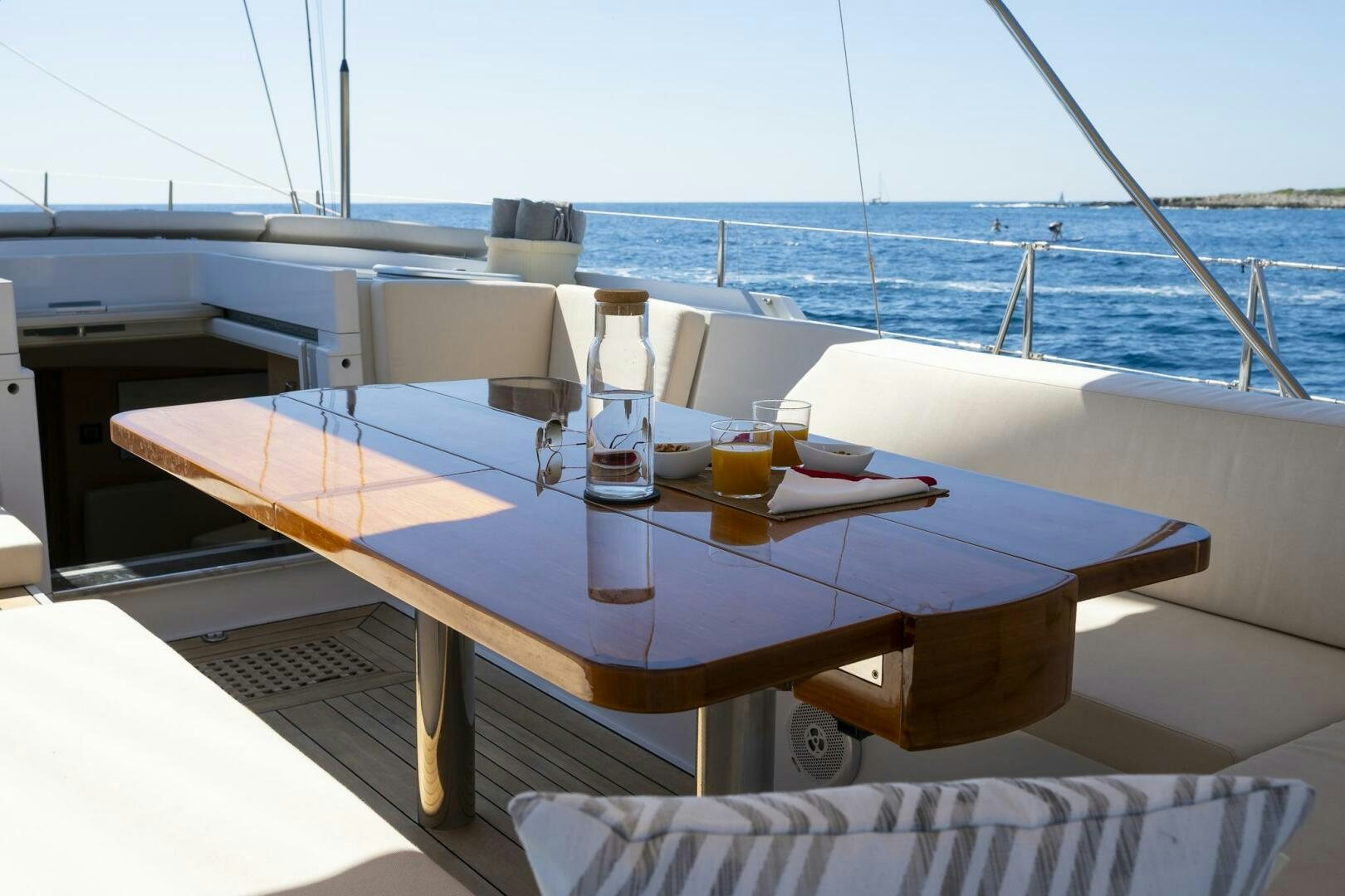 a table with a glass of beer on it aboard HANNO Yacht for Sale