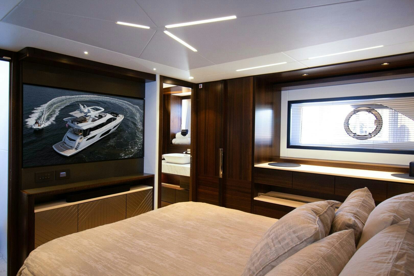 a bed with a picture on the wall aboard LAGO PARADISE Yacht for Sale