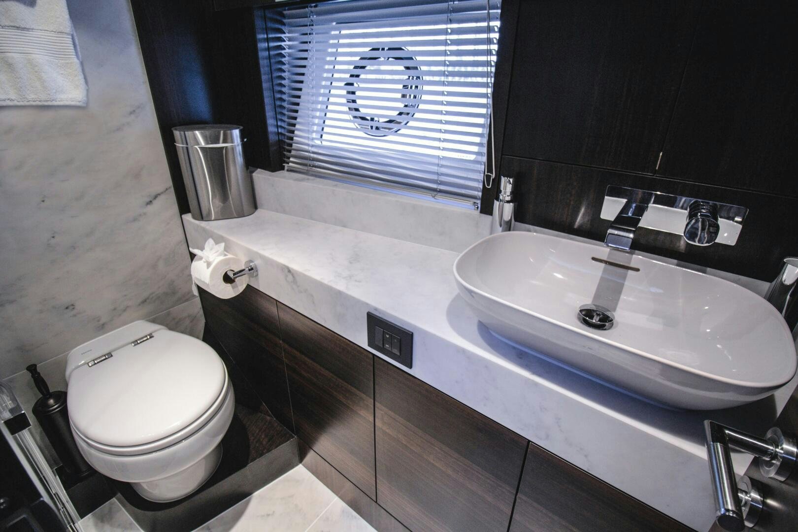 a bathroom with a sink and a toilet aboard LAGO PARADISE Yacht for Sale
