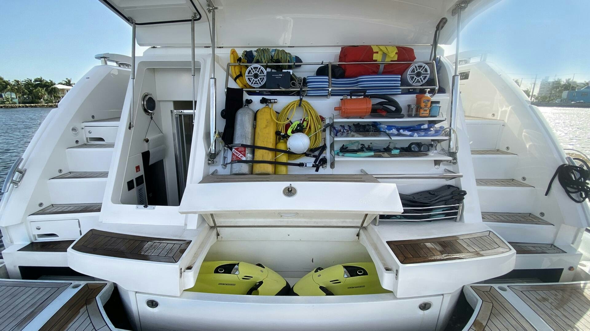 a boat with a yellow and red kayak on the deck aboard LAGO PARADISE Yacht for Sale