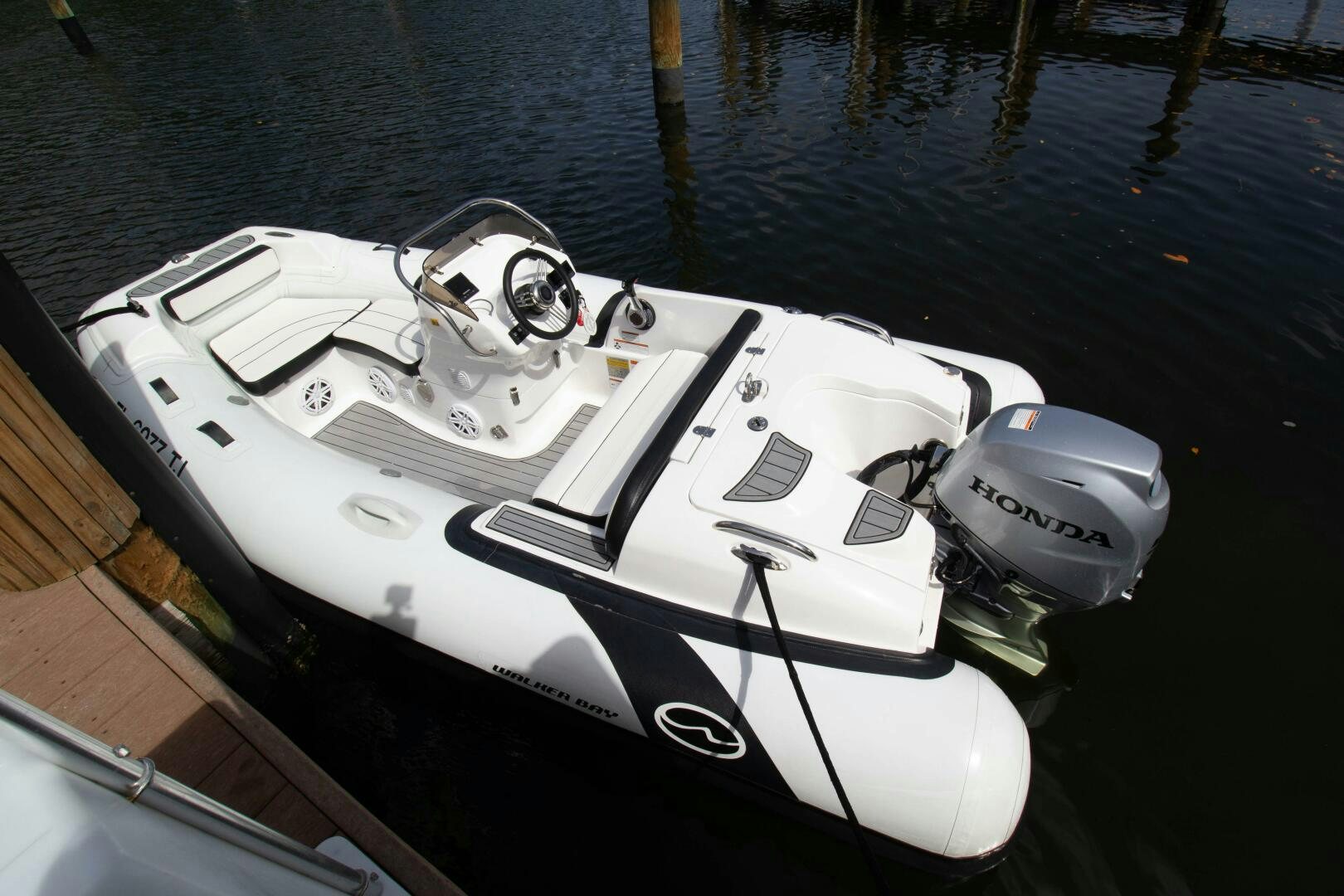 a white boat with a steering wheel aboard LAGO PARADISE Yacht for Sale