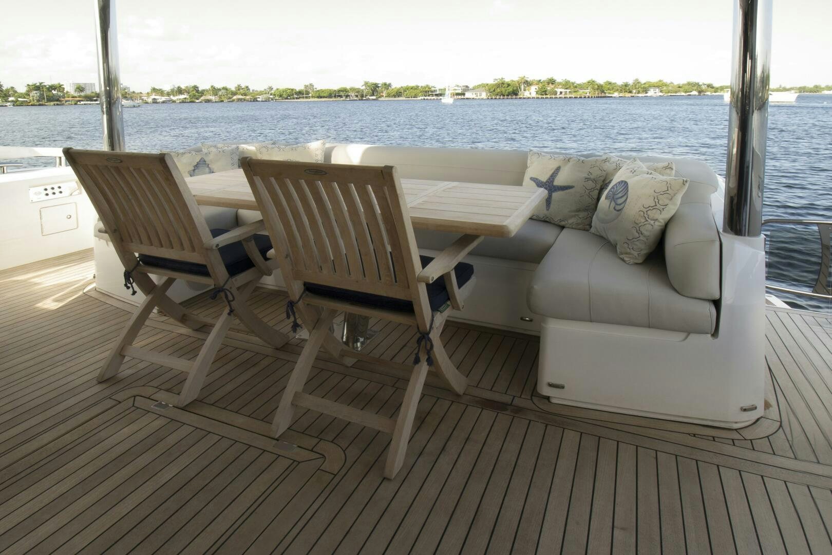 a couple of chairs on a deck overlooking a body of water aboard LAGO PARADISE Yacht for Sale