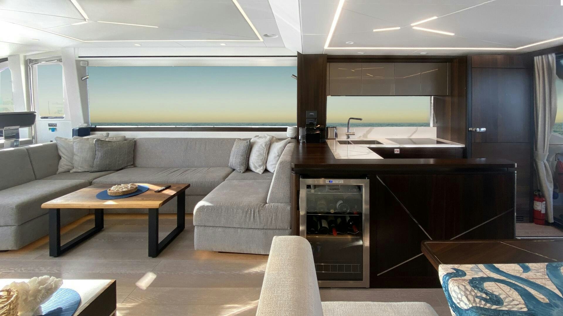 a living room with a couch and a table aboard LAGO PARADISE Yacht for Sale