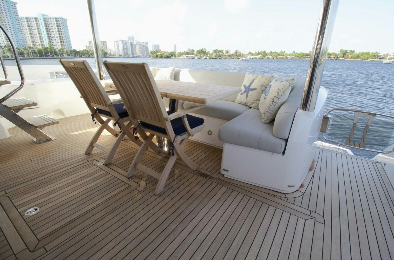 a deck with chairs and a view of a city aboard LAGO PARADISE Yacht for Sale