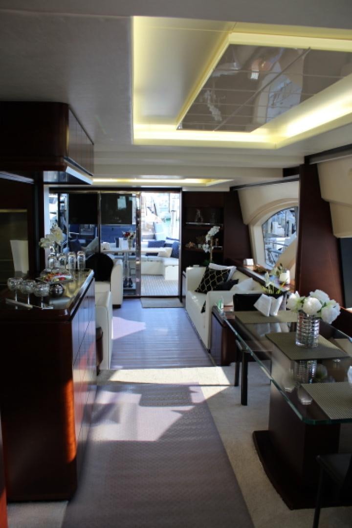 a room with a large window and a table with chairs and a person standing in the doorway aboard MINIMAL RISK Yacht for Sale