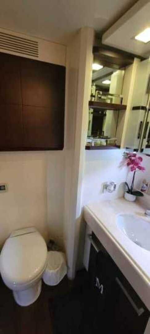 a bathroom with a toilet and a sink aboard MINIMAL RISK Yacht for Sale