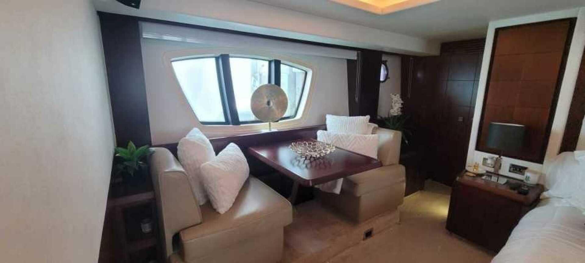 a room with a table and couches aboard MINIMAL RISK Yacht for Sale