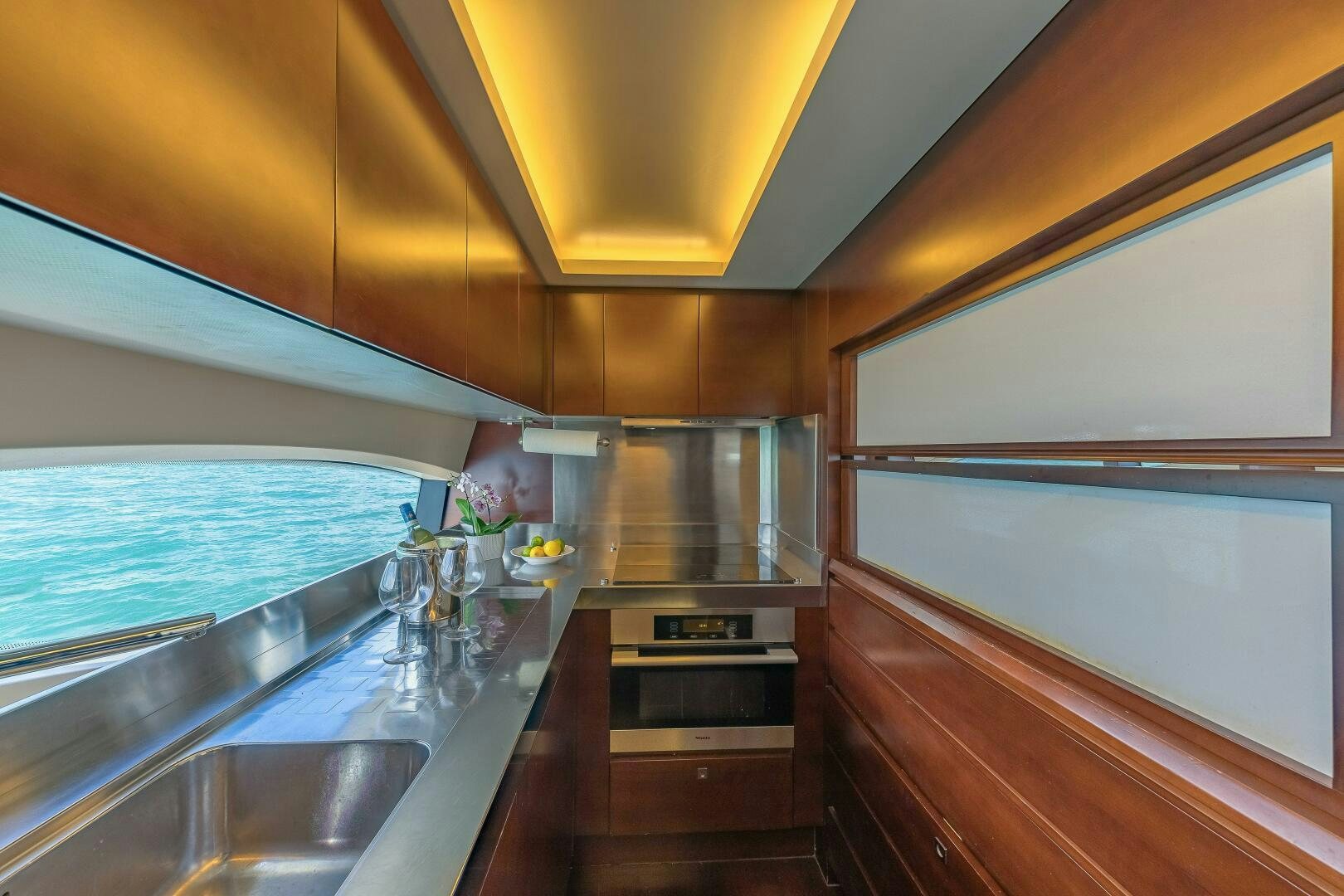a kitchen with a sink and cabinets aboard MINIMAL RISK Yacht for Sale