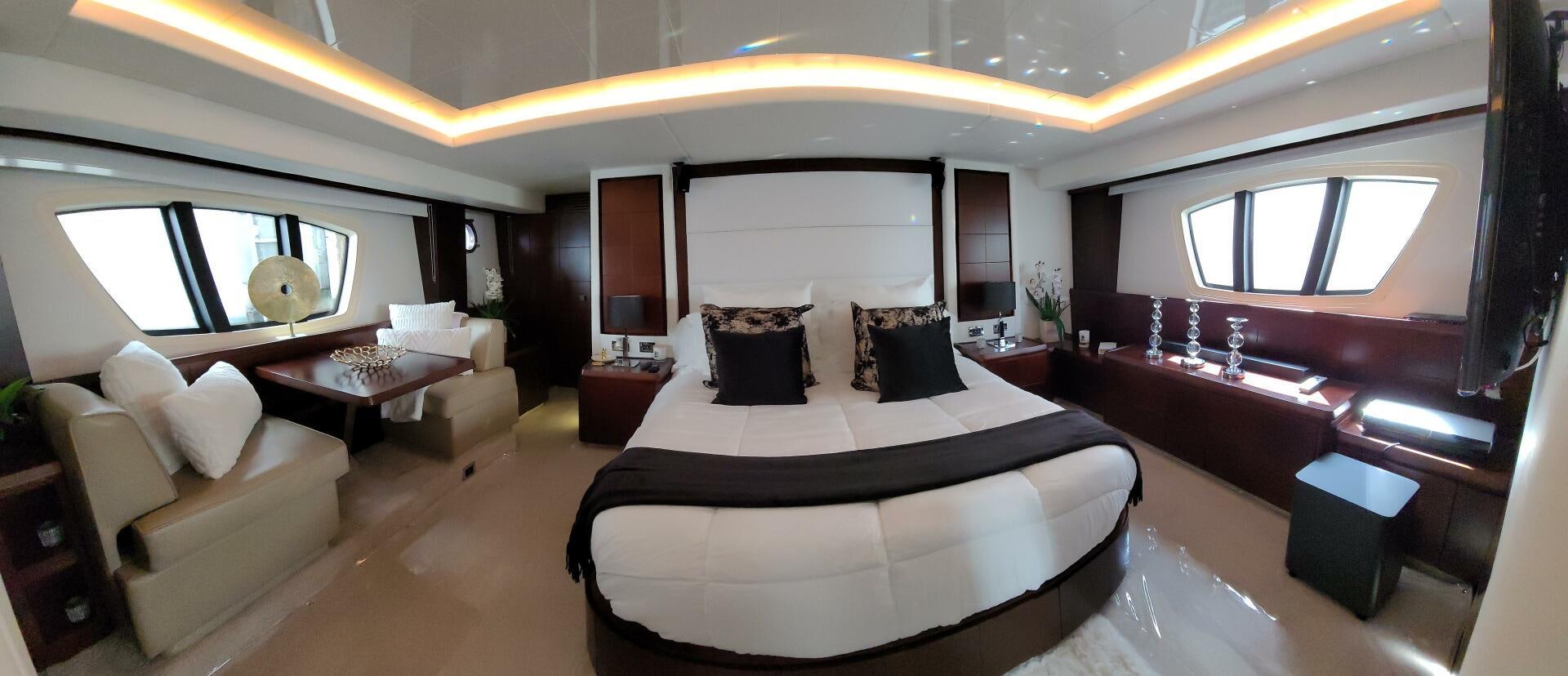a large room with a bed and a large mirror aboard MINIMAL RISK Yacht for Sale