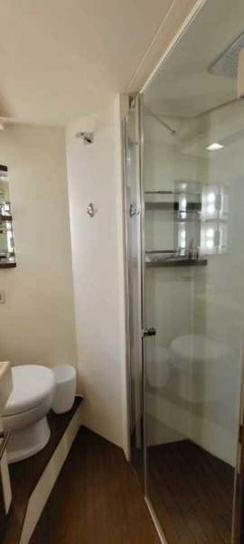 a bathroom with a glass shower aboard MINIMAL RISK Yacht for Sale