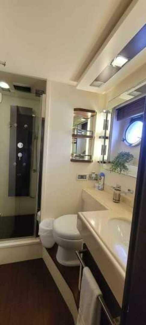 a bathroom with a tub sink and toilet aboard MINIMAL RISK Yacht for Sale