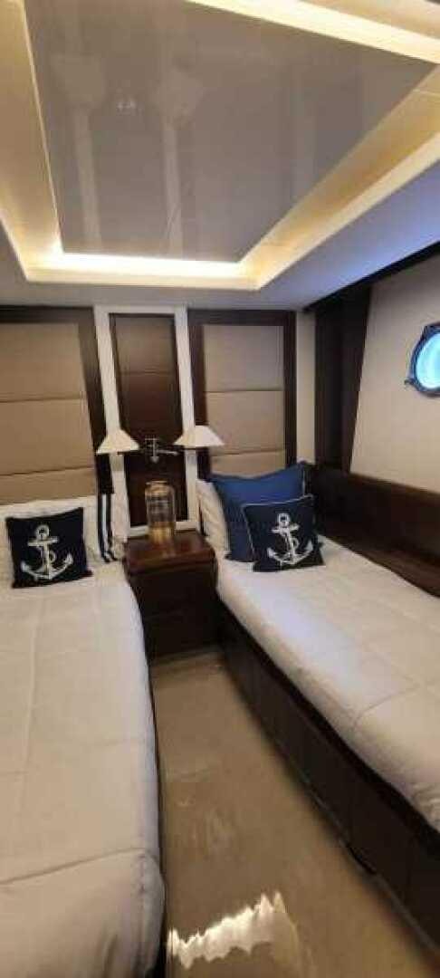 a room with a bed and a lamp aboard MINIMAL RISK Yacht for Sale