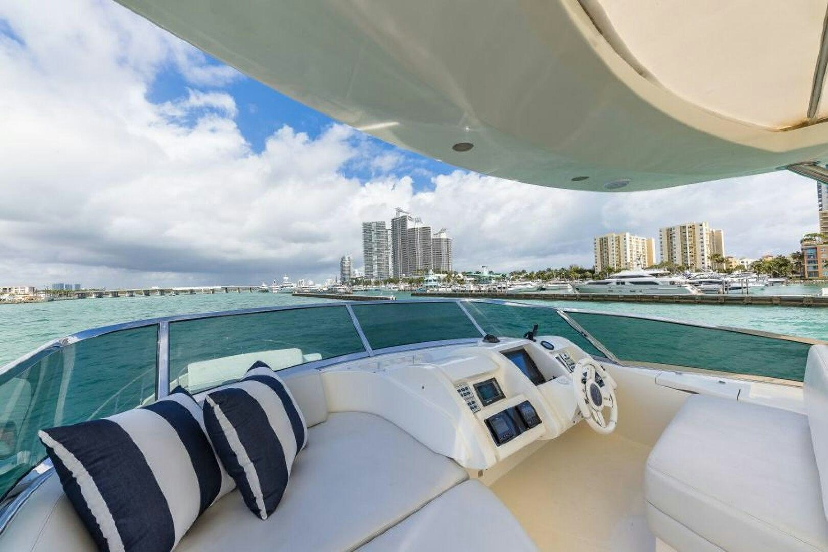a large white boat on a large body of water aboard MINIMAL RISK Yacht for Sale