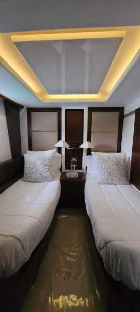 a room with a bed and a mirror aboard MINIMAL RISK Yacht for Sale