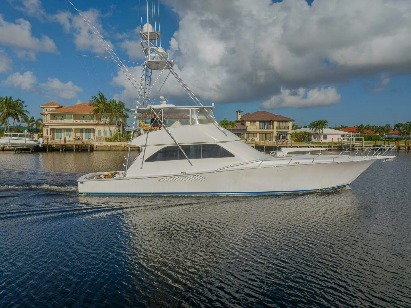 a white boat in a harbor aboard DON'T STOP BELIEVIN Yacht for Sale