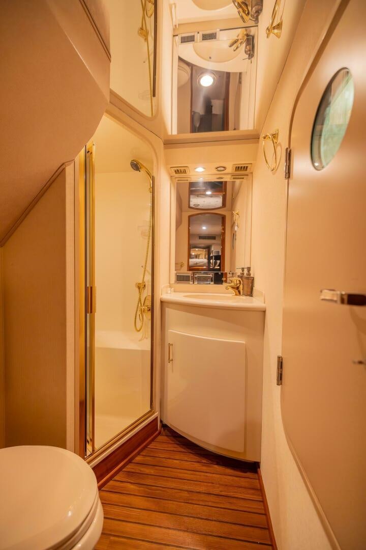 a bathroom with a shower and toilet aboard DON'T STOP BELIEVIN Yacht for Sale