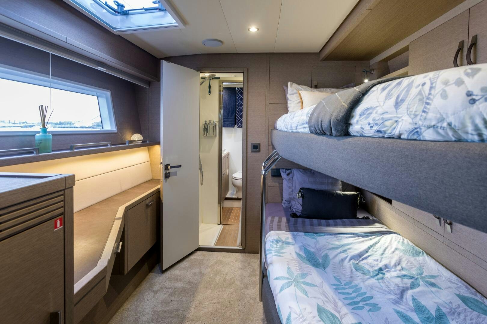 a bedroom with a bed and a desk aboard SECOND WAVE Yacht for Sale