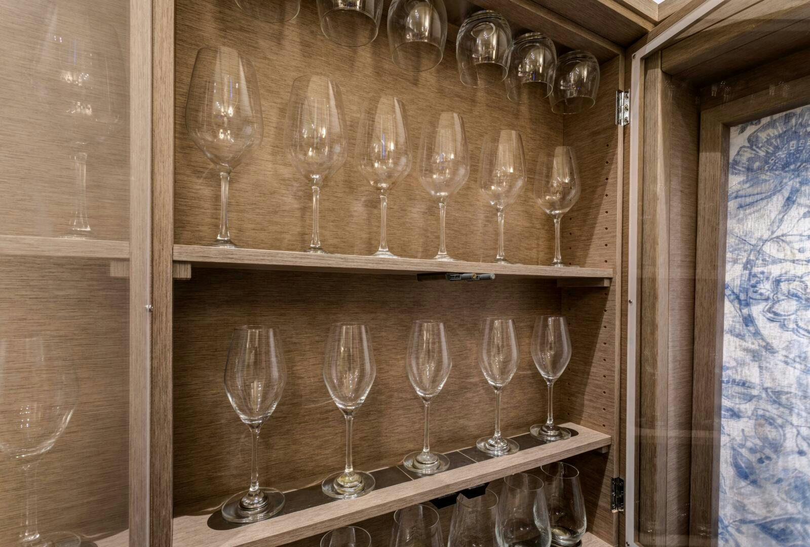 a group of wine glasses on a shelf aboard SECOND WAVE Yacht for Sale