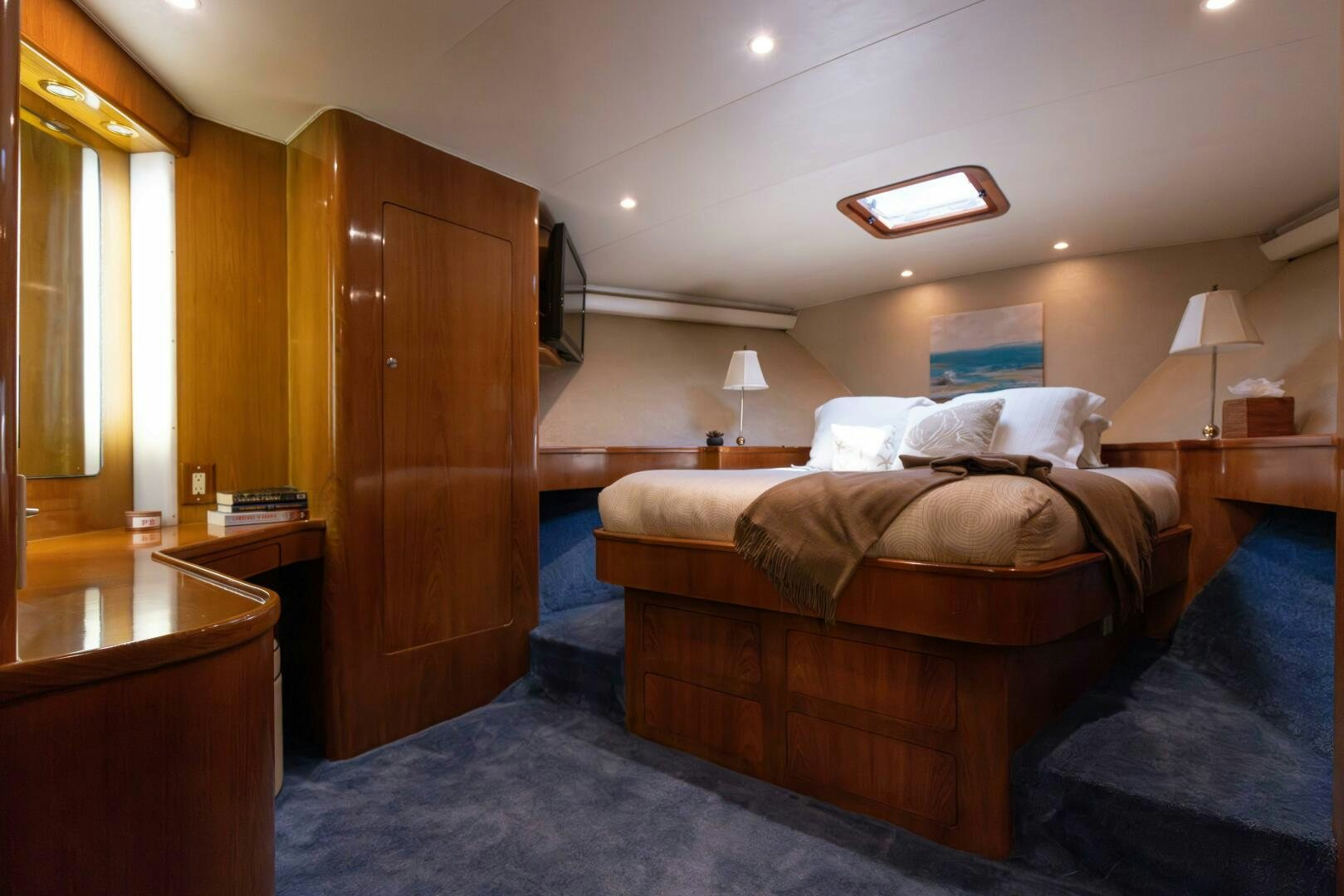 a bedroom with a bed and a desk aboard DIXIE Yacht for Sale
