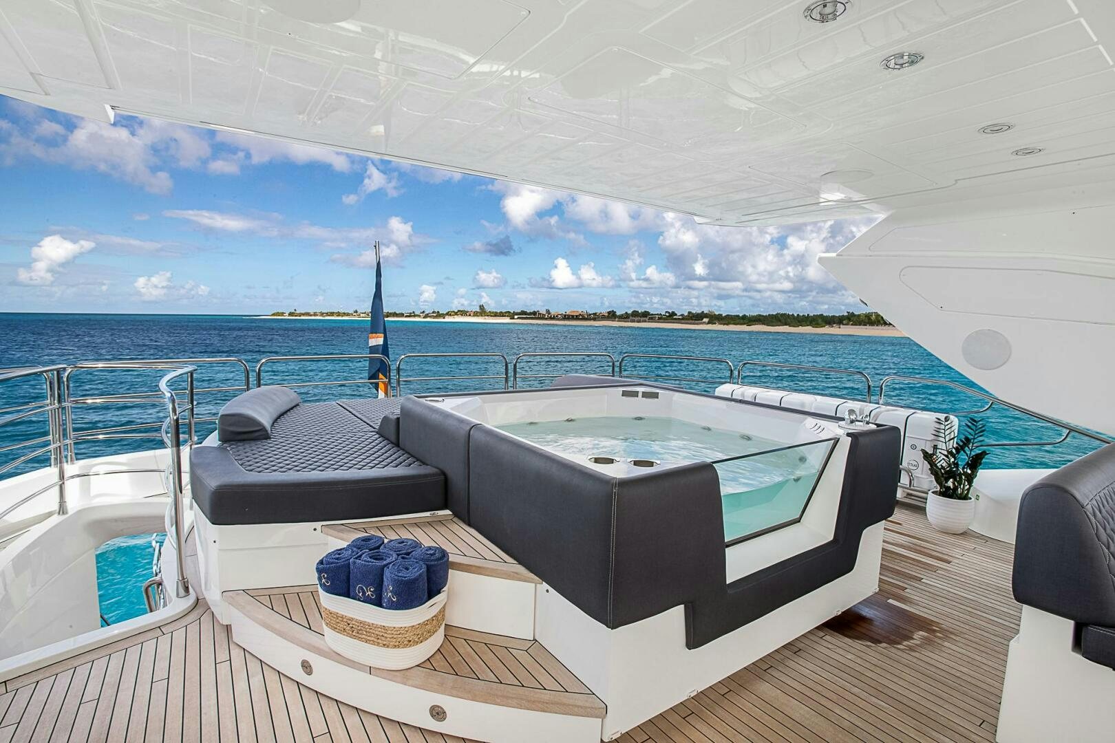 a large pool with a large blue sky and clouds aboard EVEREAST Yacht for Sale