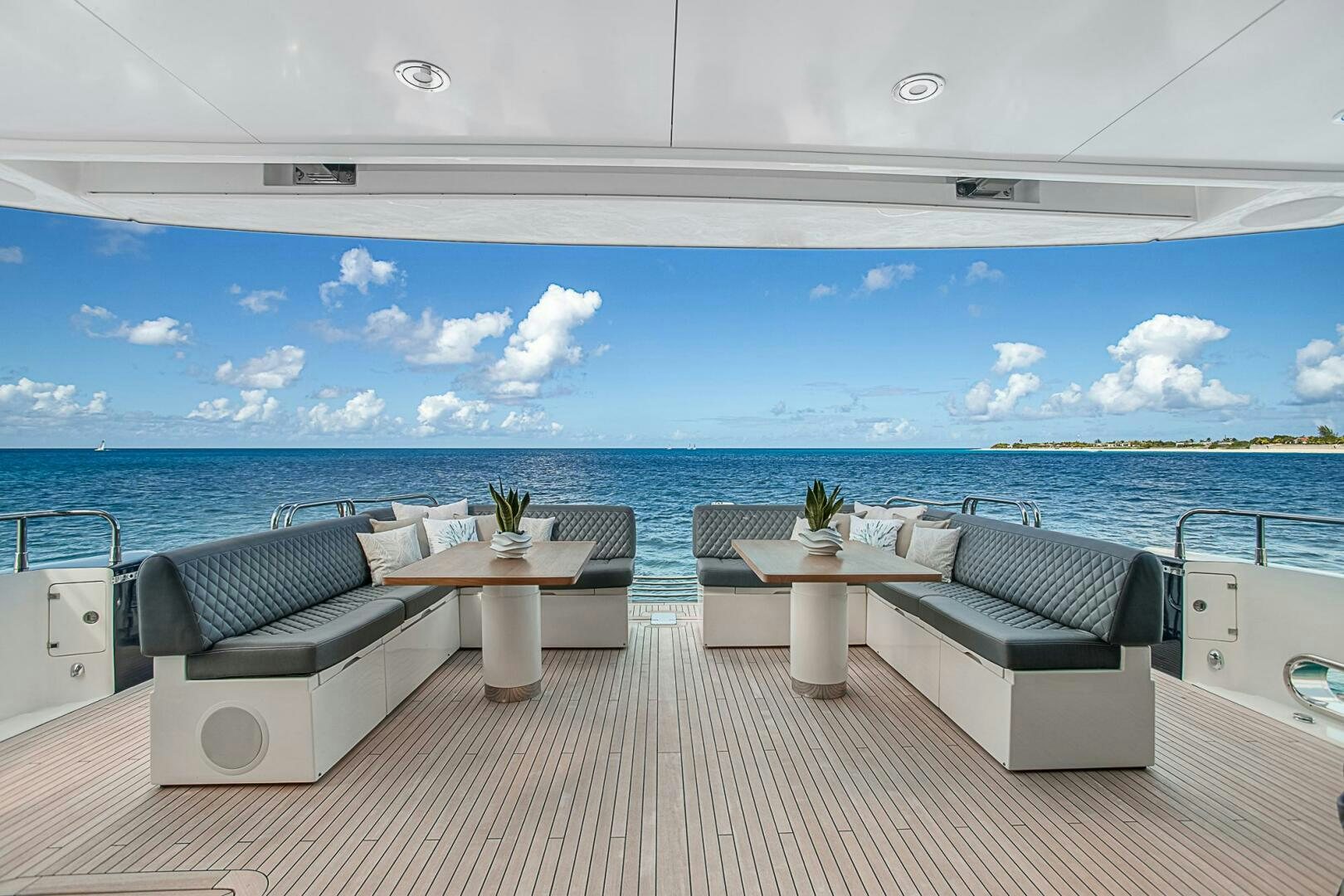 a deck with chairs and tables aboard EVEREAST Yacht for Sale