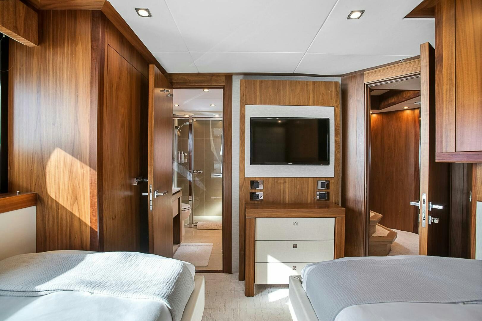 a bedroom with a bed and a television aboard EVEREAST Yacht for Sale