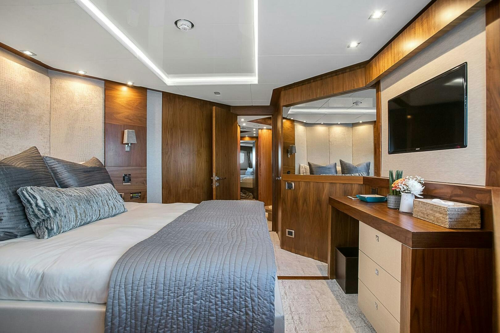 a bedroom with a bed and a desk aboard EVEREAST Yacht for Sale