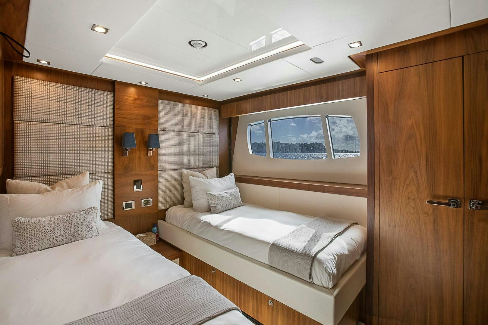 a room with a couple of beds aboard EVEREAST Yacht for Sale