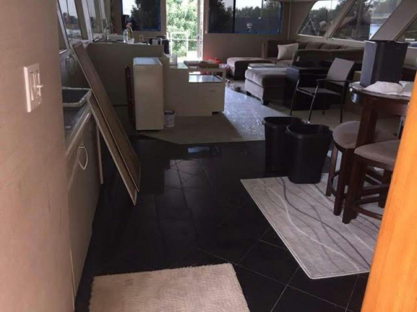 a kitchen with a bar and a table and chairs aboard SOUTHERN BREEZE Yacht for Sale