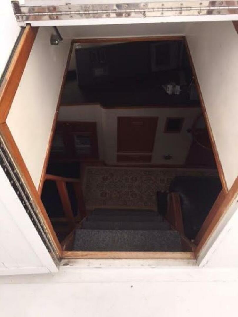 a wooden cabinet with a black frame aboard SOUTHERN BREEZE Yacht for Sale