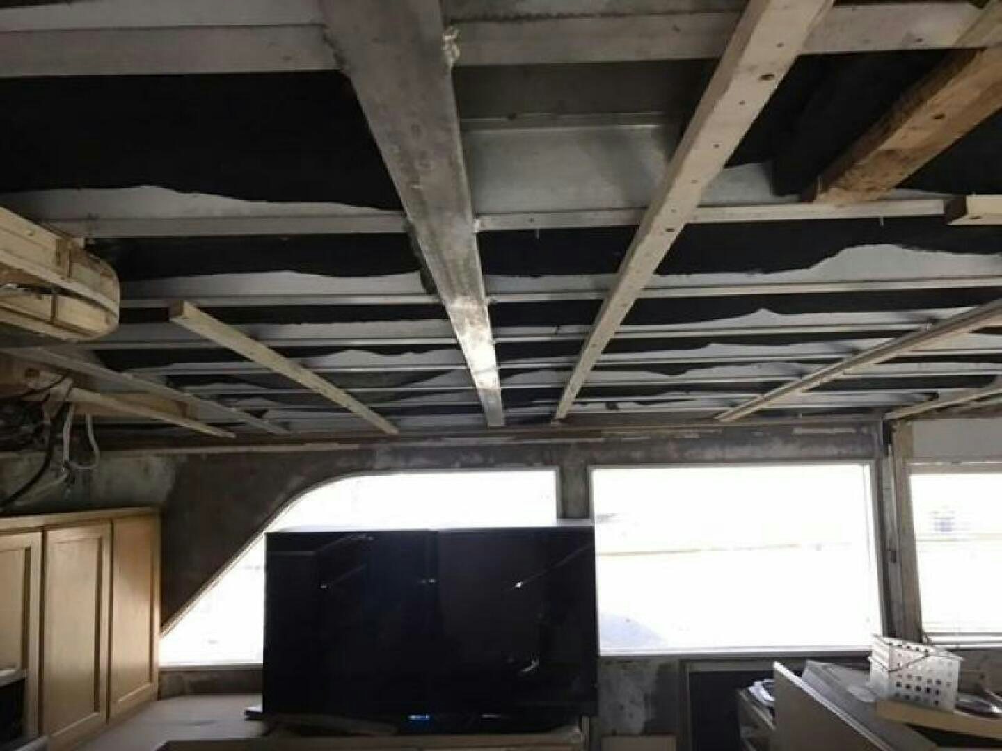 a room with a tv and a shelf with books aboard SOUTHERN BREEZE Yacht for Sale