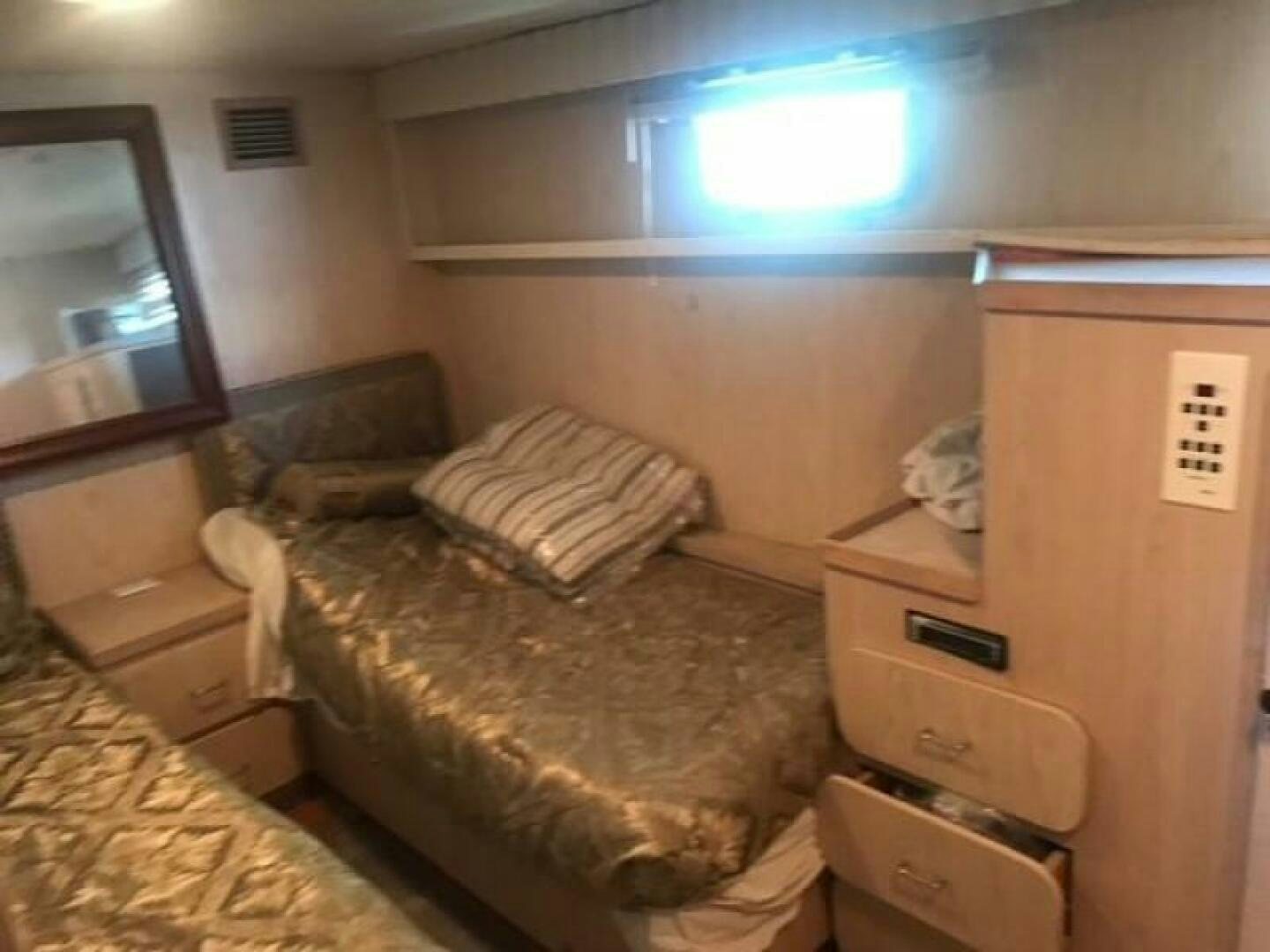 a bed with a desk and a tv on the wall aboard SOUTHERN BREEZE Yacht for Sale