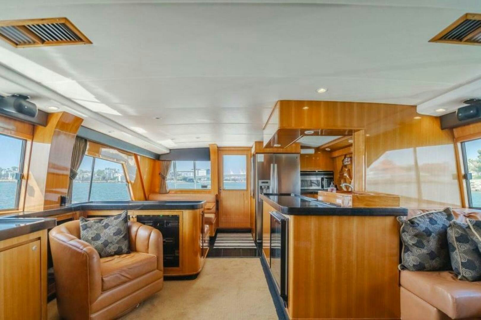 a living room with a couch and a kitchen aboard FAN TAIL I Yacht for Sale