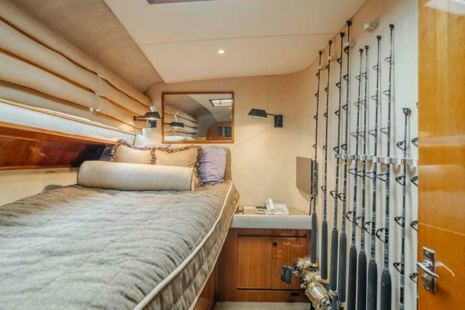 a bedroom with a bed and a mirror aboard FAN TAIL I Yacht for Sale