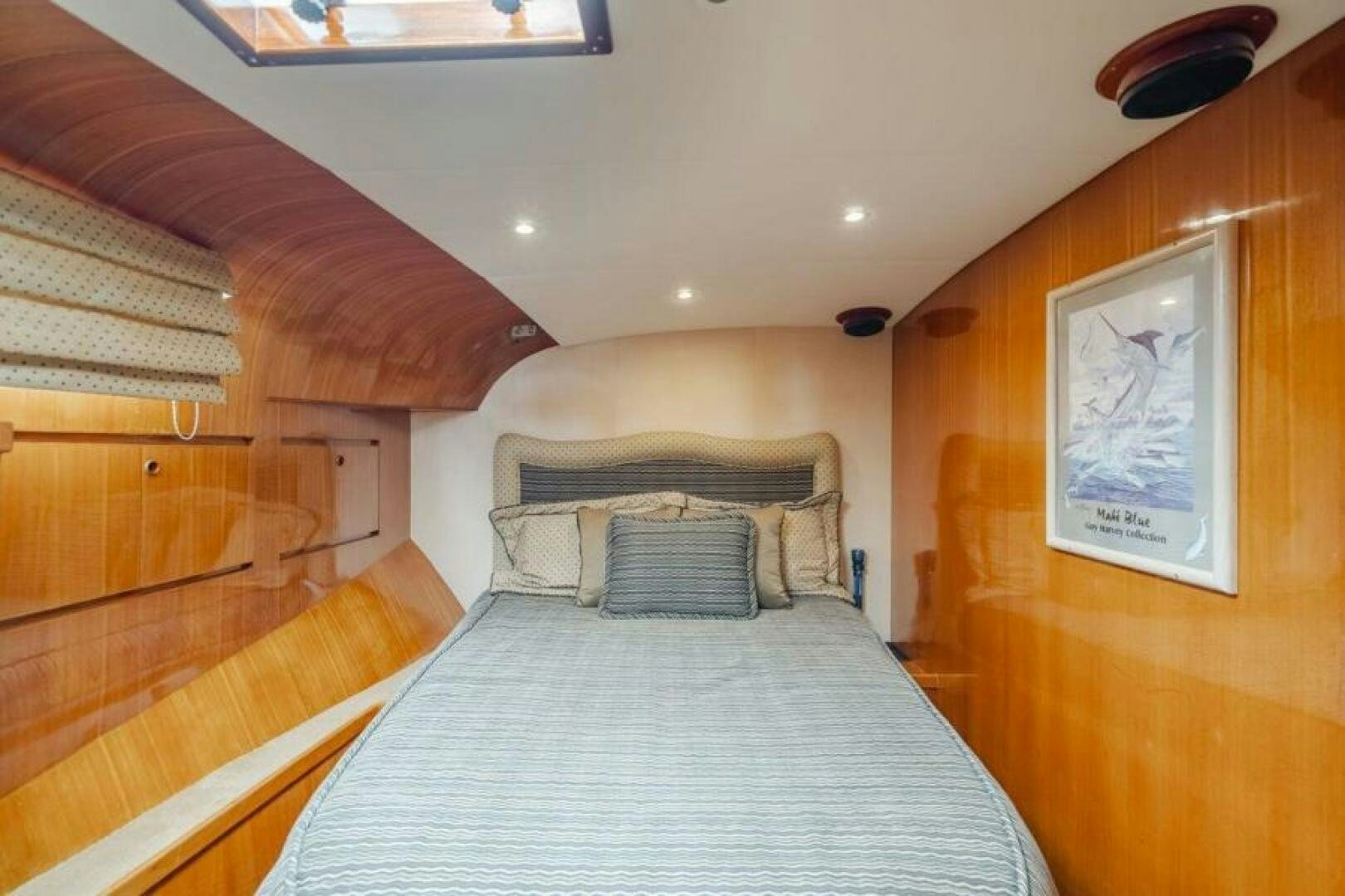a bedroom with a bed and a wood cabinet aboard FAN TAIL I Yacht for Sale